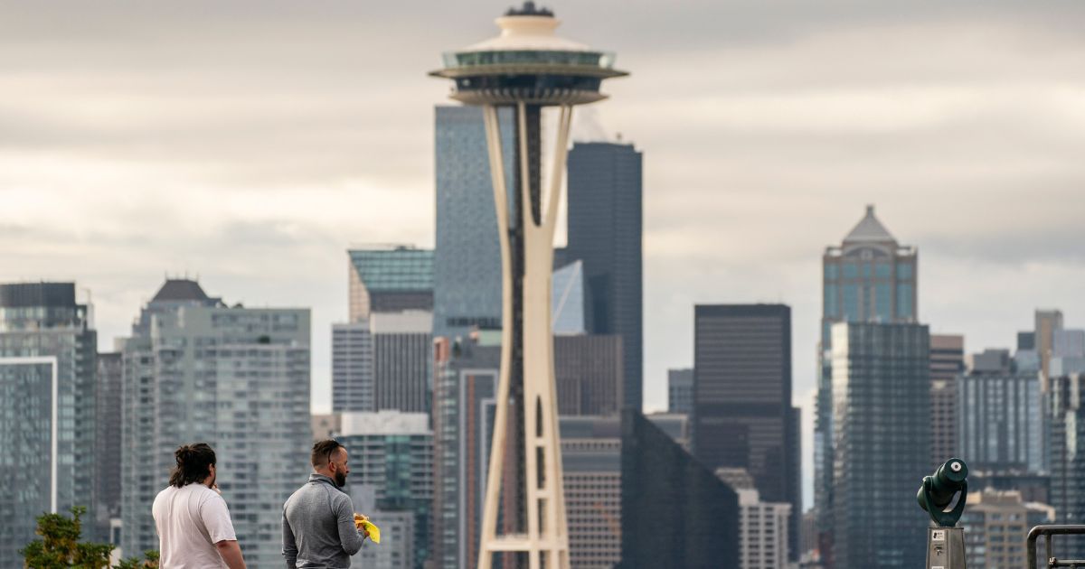 People take in a view of the city's skyline on June 10, 2021, in Seattle.