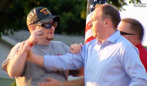 Rep. Lee Zeldin tries to fend off a man during a campaign event Thursday in Fairport, New York.