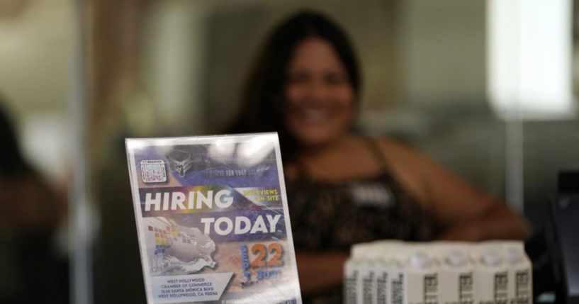 a hiring sign at a booth for prospective employers