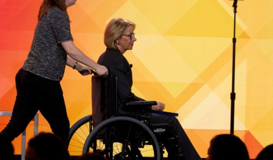 Then-Education Secretary Betsy DeVos leaves the stage in a wheelchair after speaking during the U.S. Conference of Mayors' annual meeting in Washington, D.C., on Jan. 24, 2019.