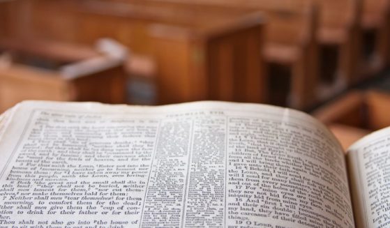 A Bible lays open in a church in the above stock image.