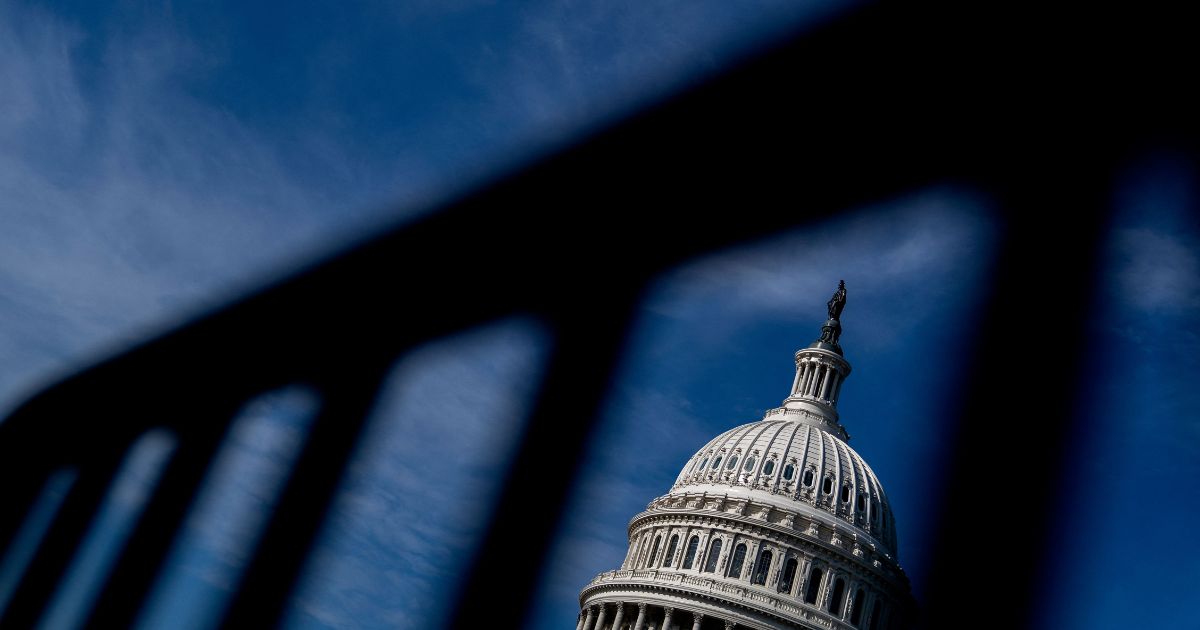 The U.S. Capitol is seen through a police barricade in Washington, D.C., on Tuesday.
