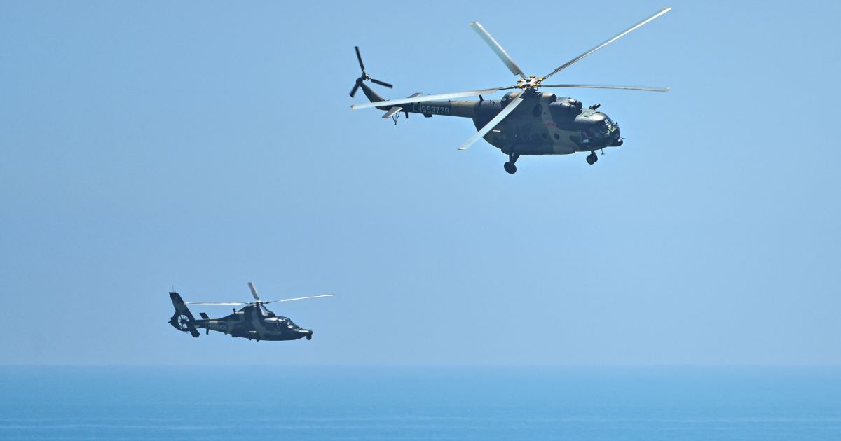 Chinese military helicopters fly past Pingtan island, one of mainland China's closest points from Taiwan, on Thursday ahead of massive military drills off Taiwan following House Speaker Nancy Pelosi's visit to the self-ruled island.