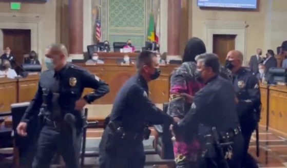During an LA city council meeting, a woman was arrested after climbing past the podium and walking towards the city council president as she was speaking.
