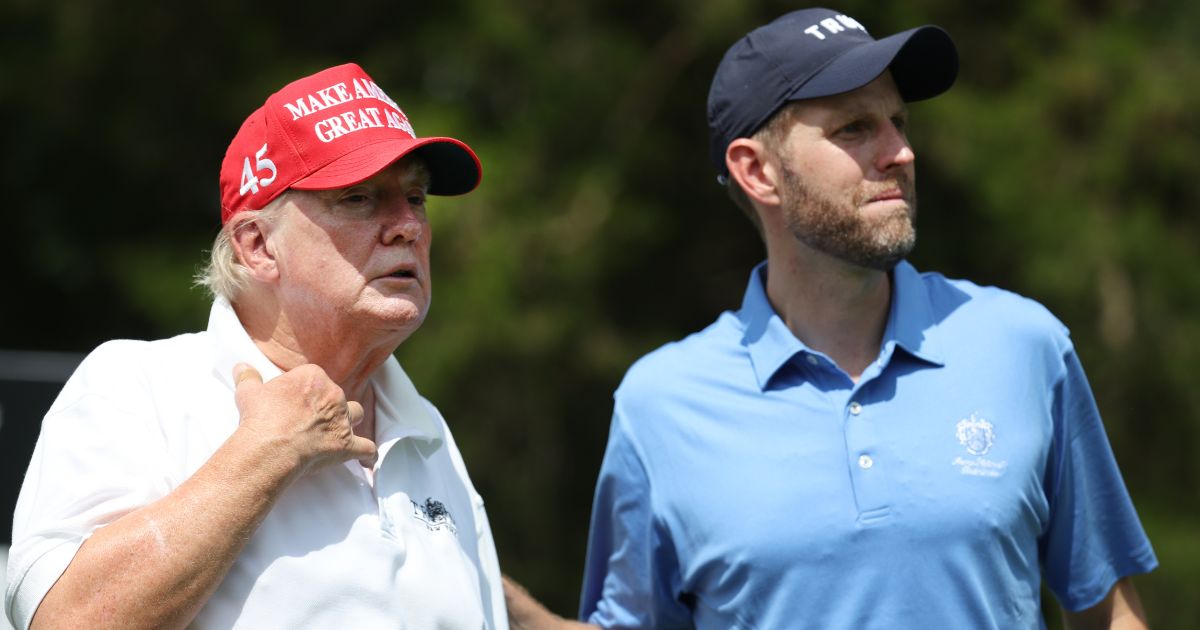 Former President Donald Trump and son Eric Trump wait together during the pro-am prior to the LIV event at Trump National Golf Club Bedminster in Bedminster, New Jersey, on July 28.