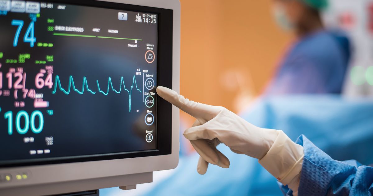 A hand touches a medical ventilator in a hospital in this stock photo.