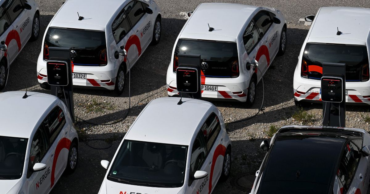 Electric vehicles are parked at charging stations in Nuremberg, Germany, on Tuesday.