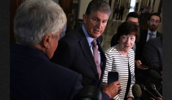 Sen. Joe Manchin (D-WV) (L) and Sen. Susan Collins (R-ME), right, speak to members of the media after they testified at a hearing on the Electoral Count Act before Senate Rules and Administration Committee Wednesday in Washington.