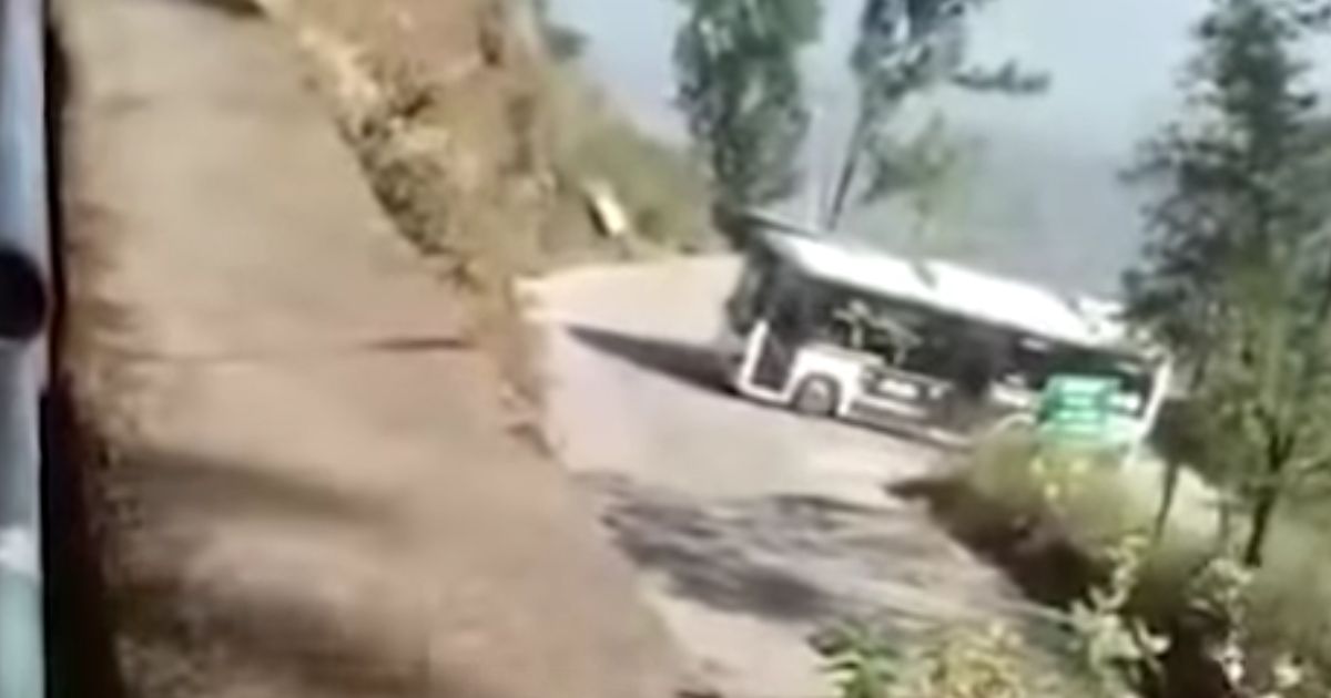 The bus slowed and stopped on the hairpin turn, then started to roll backward.