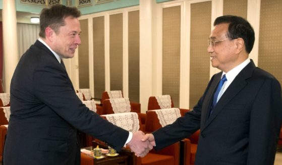 Tesla CEO Elon Musk, left, shakes hands with Chinese Premier Li Keqiang as he arrives for a meeting at the Zhongnanhai compound on Jan. 9, 2018, in Beijing.