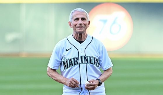 Dr. Anthony Fauci, director of the National Institute of Allergy and Infectious Diseases and chief medical adviser to President Joe Biden, throws out the ceremonial first pitch before the Seattle Mariners' game against the New York Yankees at T-Mobile Park on Tuesday.