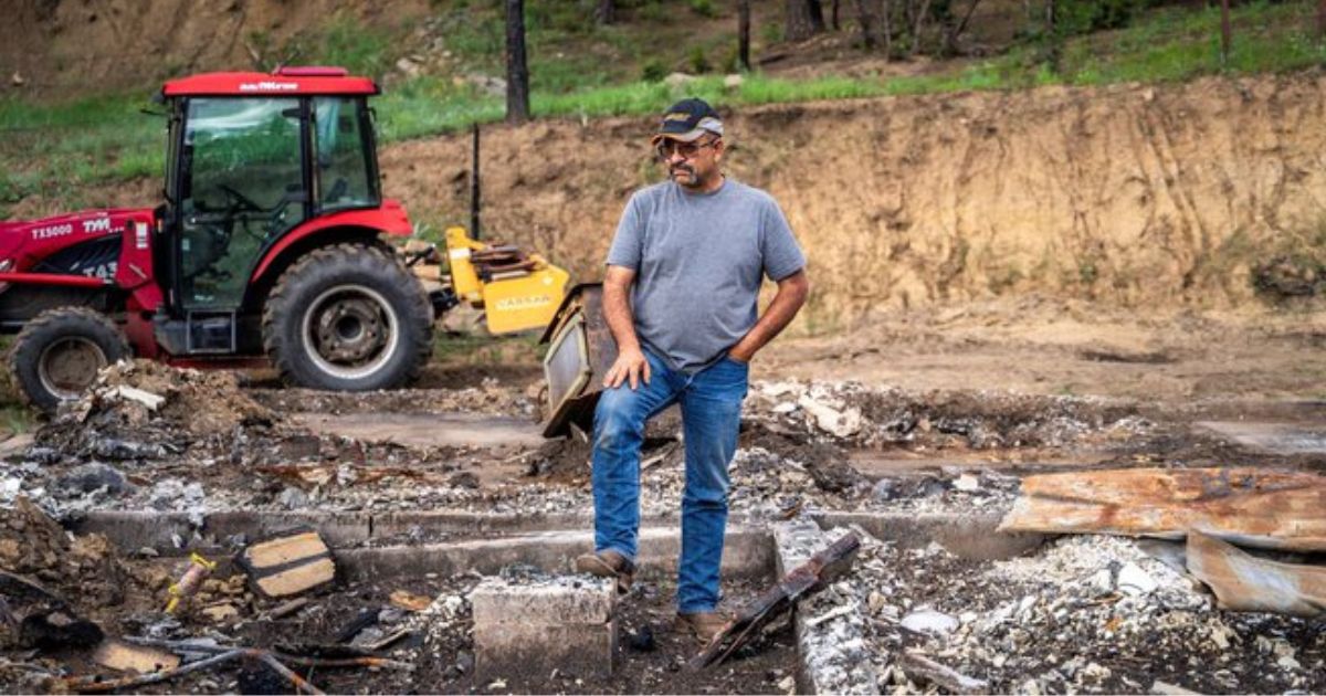 Daniel Encinias stands in the remains of the home he built in Tierra Monte, New Mexico.