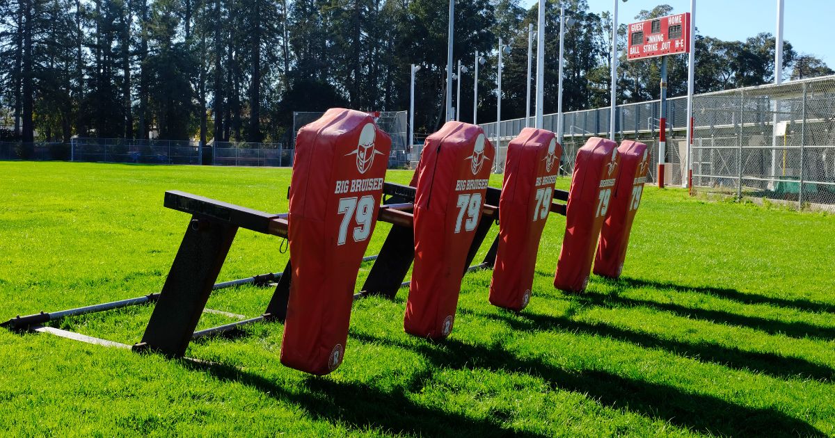 A blocking sled is set up for high school football practice.