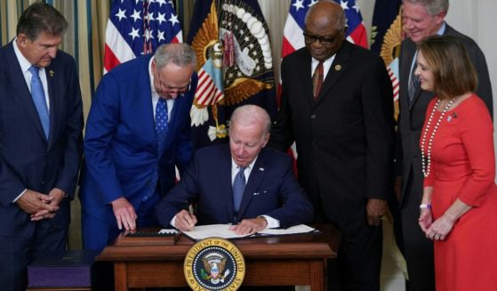 President Joe Biden signs the Inflation Reduction Act into law in the State Dining Room of the White House in Washington, D.C., on Tuesday.