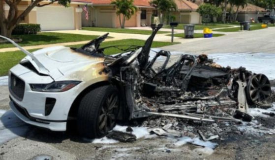 A Jaguar I-Pace battery catches fire while charging in a garage, burning the car to ash.