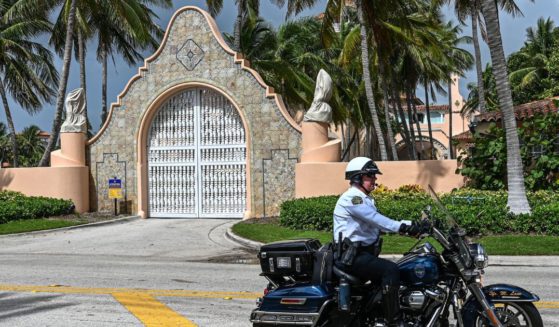 Local law enforcement officers are seen in front of former President Donald Trump's Mar-a-Lago estate in Palm Beach, Florida, on Tuesday.