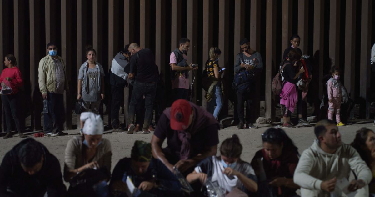 A large group of illegal immigrants waits to be processed by U.S. Border Patrol agents after crossing the U.S.-Mexico border near Yuma, Arizona, on July 11.