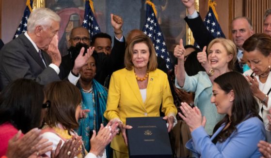 House Democrats applaud after Speaker of the House Nancy Pelosi signed the Inflation Reduction Act at the U.S. Capitol on Aug. 12 in Washington, D.C.