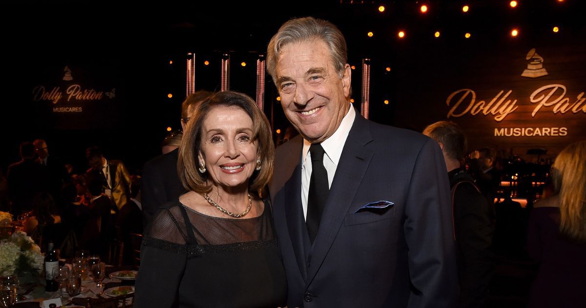 Paul Pelosi, right, and his wife, House Speaker Nancy Pelosi, attend a Los Angeles event honoring Dolly Parton in this file photo from Feburary 2019.