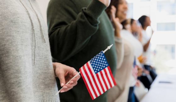 A group of people is sworn in as American citizens in this stock image.