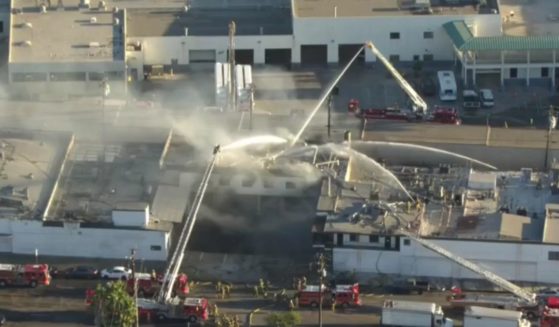 Firefighters battle a blaze at a poultry processing plant in Montebello, Calif., Sunday.