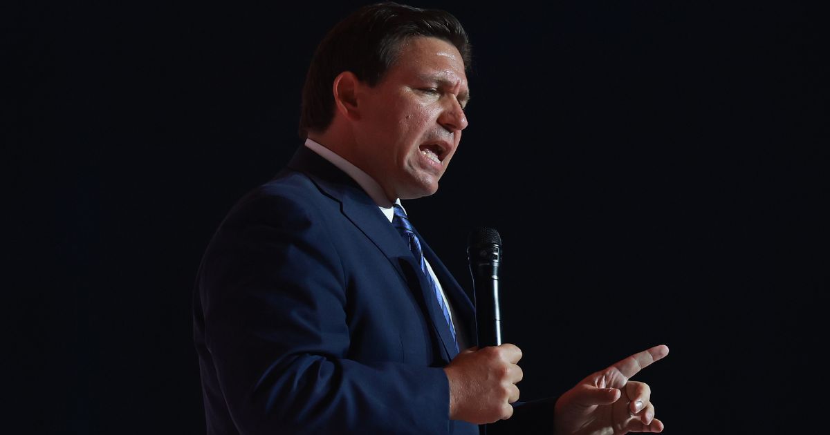 Florida Gov. Ron DeSantis, seen speaking at a July event, announced that 20 convicts are being charged with voter fraud..