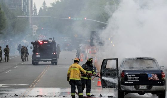 Firefighters in Bellevue, Washington, near Seattle, work to extinguish a truck fire during protests sparked over the death of George Floyd on May 31, 2020.