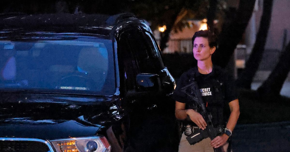 an armed Secret Service agent standing outside Mar-a-Lago