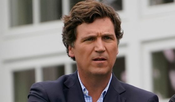Fox News host Tucker Carlson watches the final round of the Bedminster Invitational LIV Golf tournament in Bedminster, New Jersey, on July 31.
