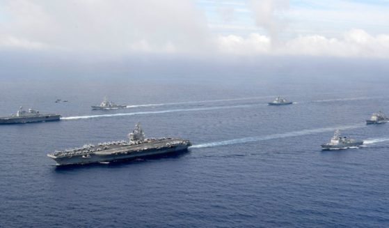 Aircraft carrier USS Ronald Reagan, seen with South Korea's Marado amphibious landing ship during recent joint naval exercises, will remain near the Taiwan Strait for the time being, Biden administration officials announced.