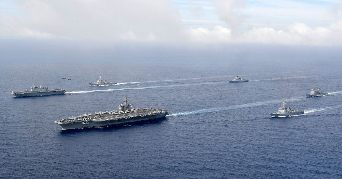 Aircraft carrier USS Ronald Reagan, seen with South Korea's Marado amphibious landing ship during recent joint naval exercises, will remain near the Taiwan Strait for the time being, Biden administration officials announced.