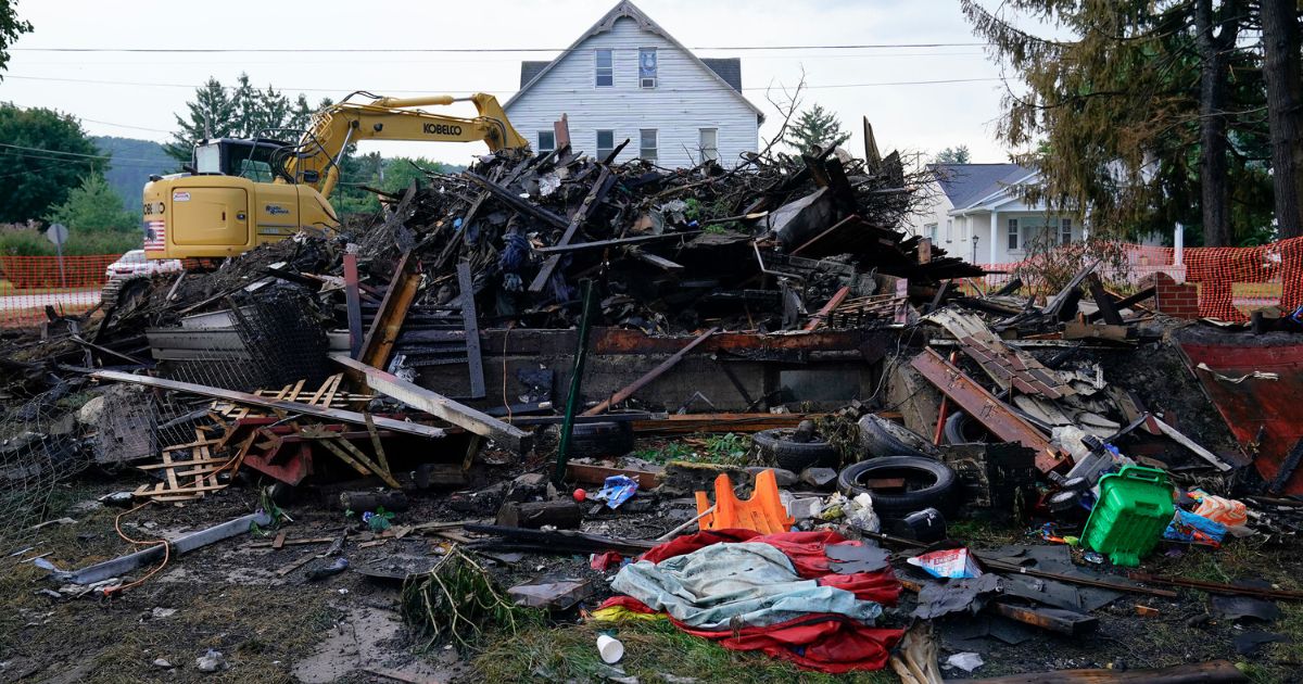 Ten people were killed as the remnants of this house fire are shown in Nescopeck, Pennsylvania, on Friday. An investigation is underway, police said.