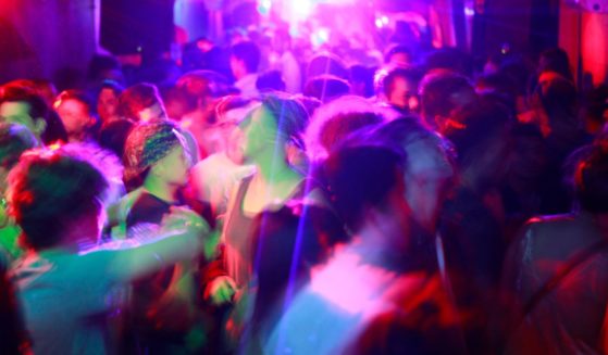 A packed dance floor at a gay nightclub.