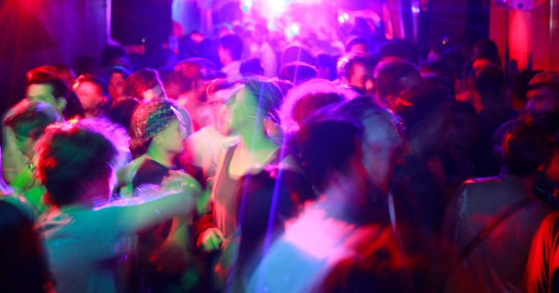 A packed dance floor at a gay nightclub.