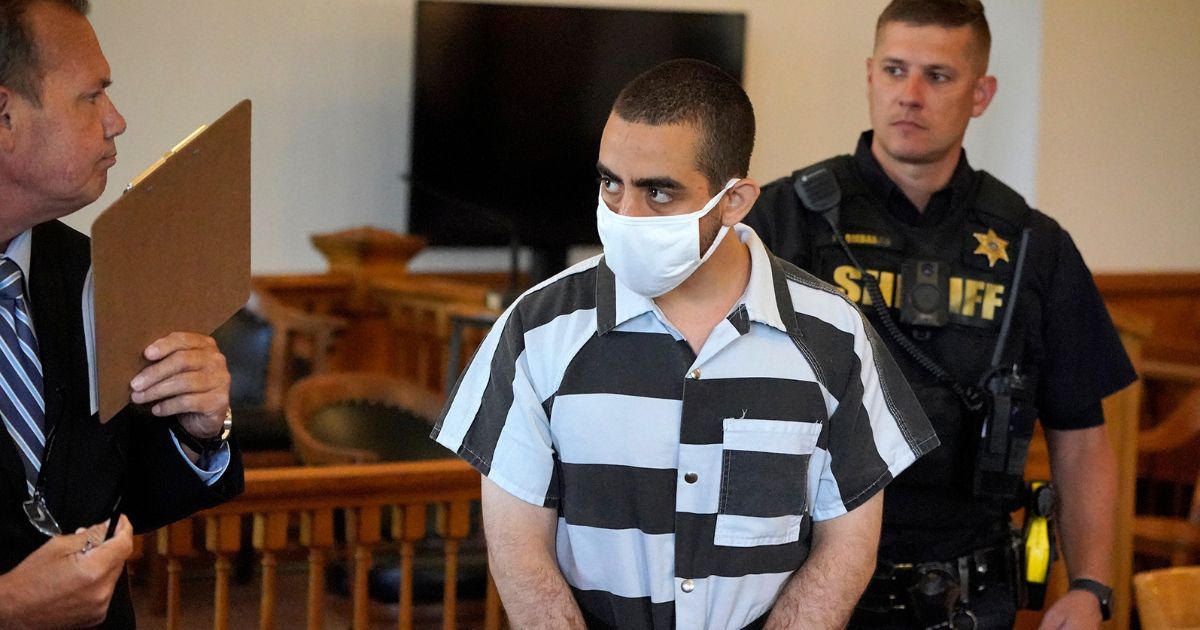Hadi Matar, 24, center, charged in Friday's stabbing attack on author Salman Rushdie, is pictured at his arraignment in the the Chautauqua County Courthouse in Mayville, New York, on Saturday.