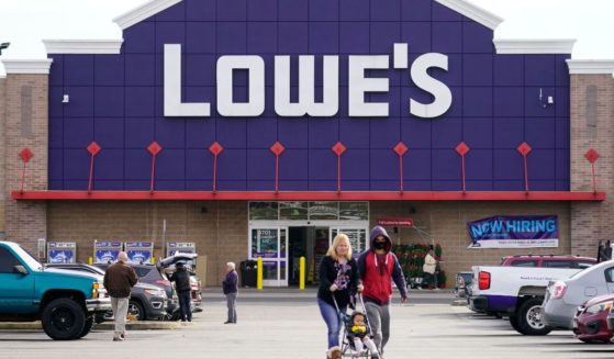 Shoppers walk in the parking lot of a Lowe's home improvement store in Philadelphia last November.