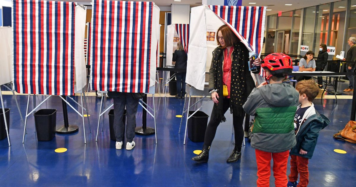 Voters enter booths to mark their ballots during an election day in New York.