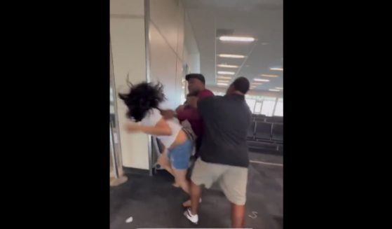 A Spirit Airlines employee was caught on camera tackling and punching a woman at Dallas Forth Worth Airport on Thursday.