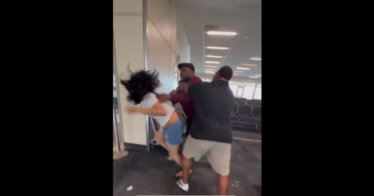 Chaos at DFW: Airline Agent Slugs Woman, Continues to Pummel Her as Bystanders Jump to Separate the Two