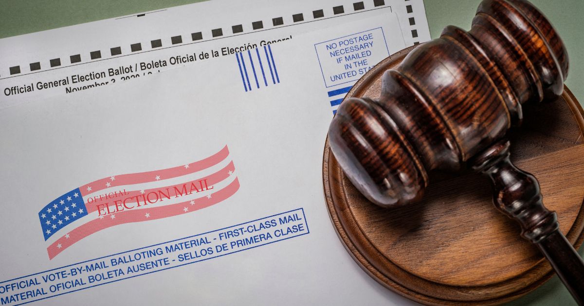 A gavel rests on a mail-in ballot in this stock image.