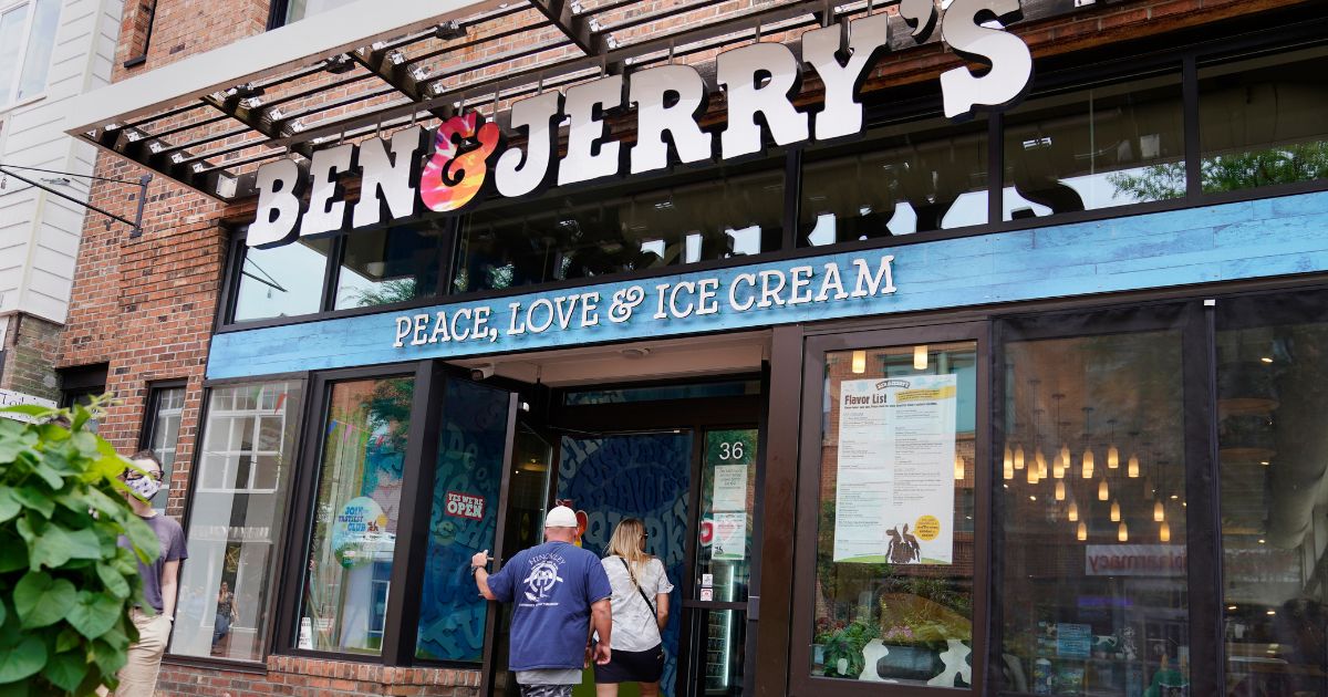 Two patrons enter a Ben & Jerry's ice cream shop on July 20, 2021, in Burlington, Vermont.
