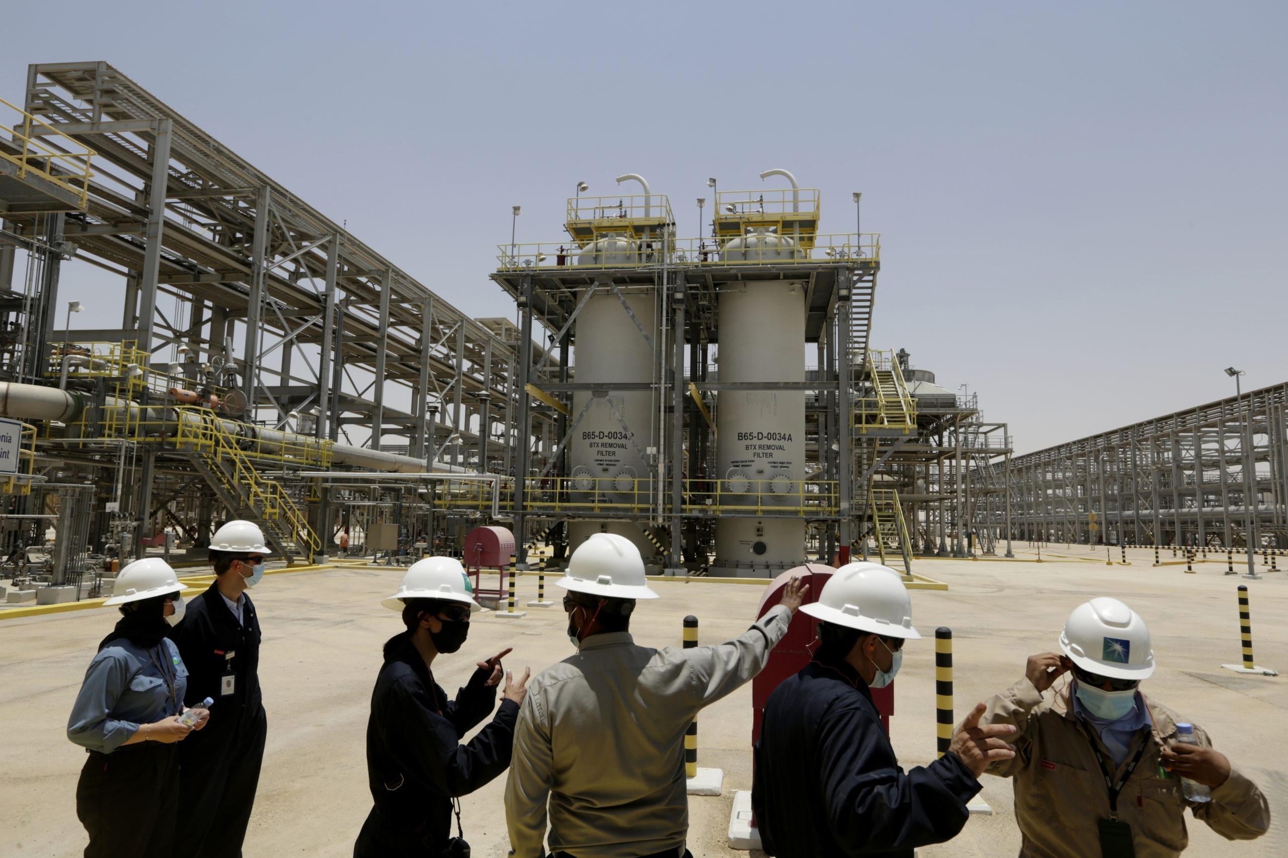Saudi Arabian Aramco engineers and journalists look at the Hawiyah Natural Gas Liquids Recovery Plant in Hawiyah, Saudi Arabia, on June 28, 2021.
