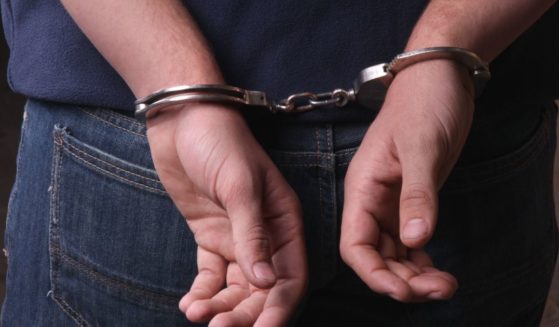 The above stock image is of someone if handcuffs.