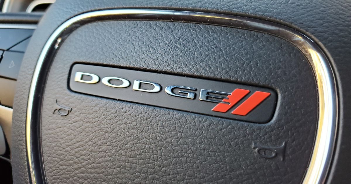 The above image is a close-up of a car steering wheel featuring the Dodge logo in Lafayette, California.