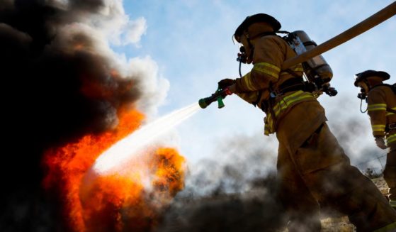 The above stock image is of firefighters extinguishing a burning house fire.