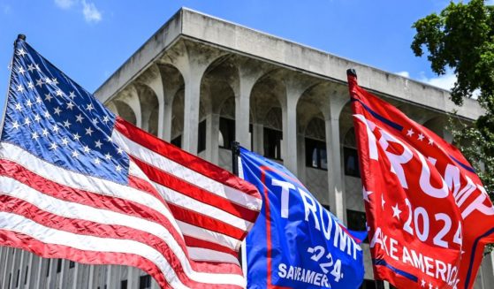 Flags fly outside the Paul G. Rogers Federal Building in West Palm Beach, Florida, on Thursday.