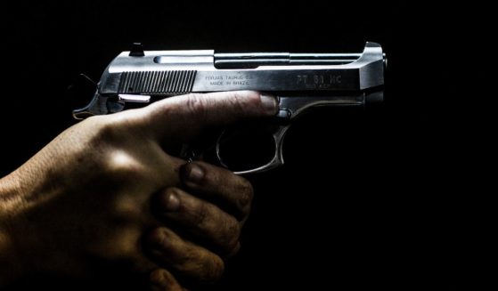 A man holds a gun in Sao Goncalo, Rio de Janeiro, Brazil, on Sept. 3, 2018.