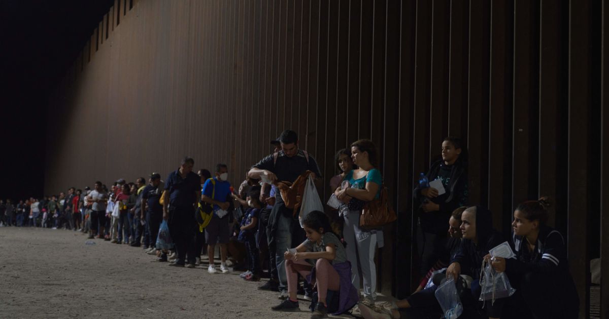 Migrants wait to be processed by Border Patrol after illegally crossing the U.S.-Mexico border in Yuma, Arizona, on July 11.