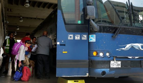 an immigrant family boarding a Greyhound bus