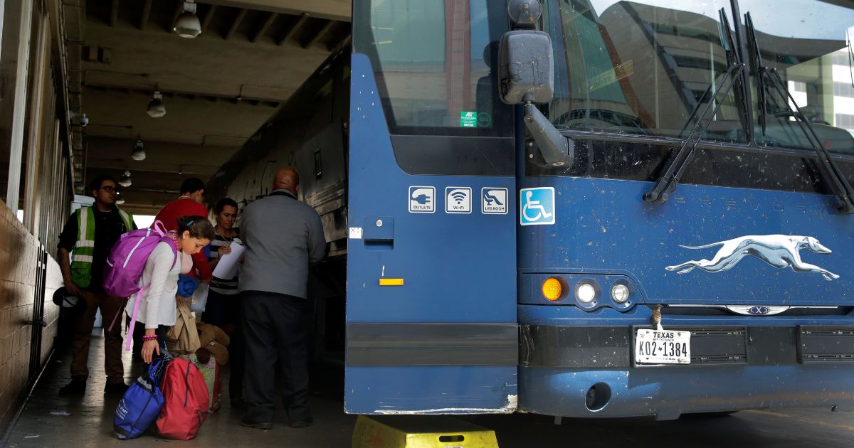 an immigrant family boarding a Greyhound bus